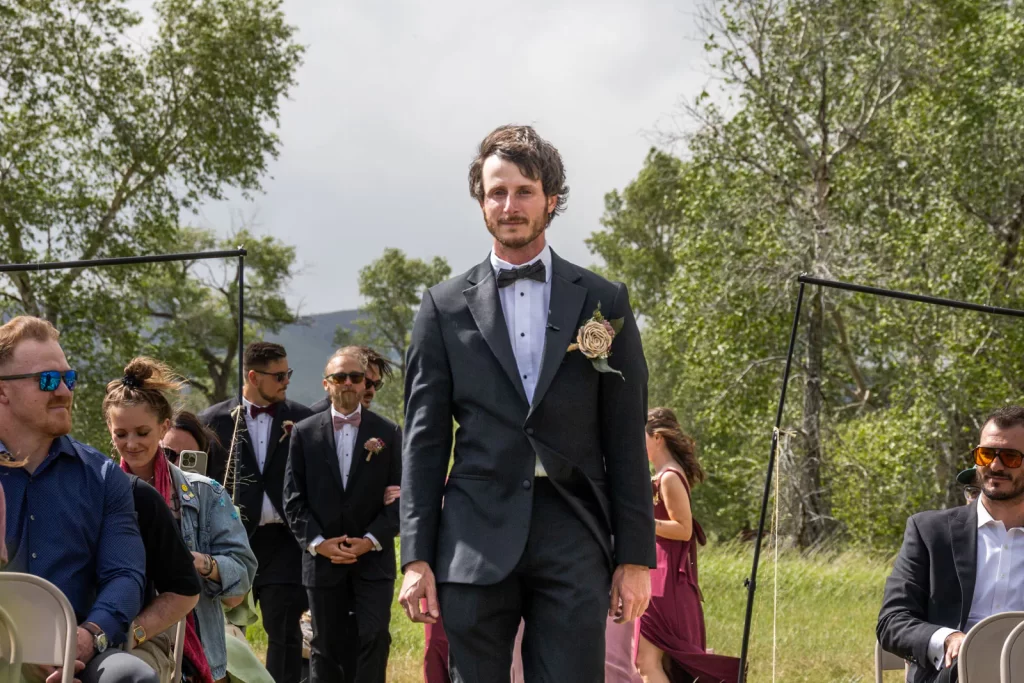 Groom walking down isle