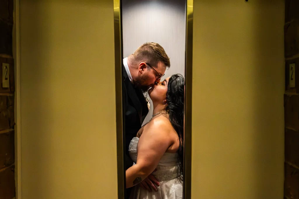 Couple kissing as elevator doors close