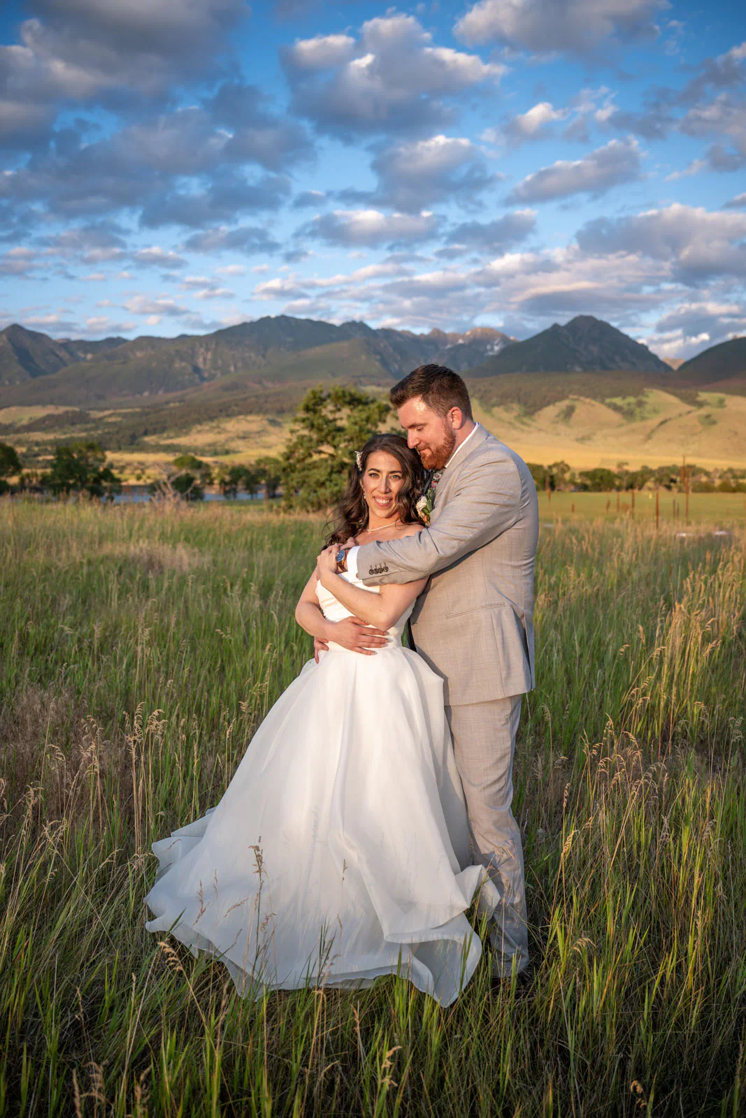 wedding couple golden hour in Montana field with Absaroka Mountains