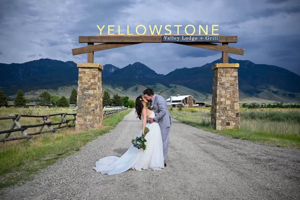 Kissing under the Yellowstone Valley Lodge sign, Livingston, Montana