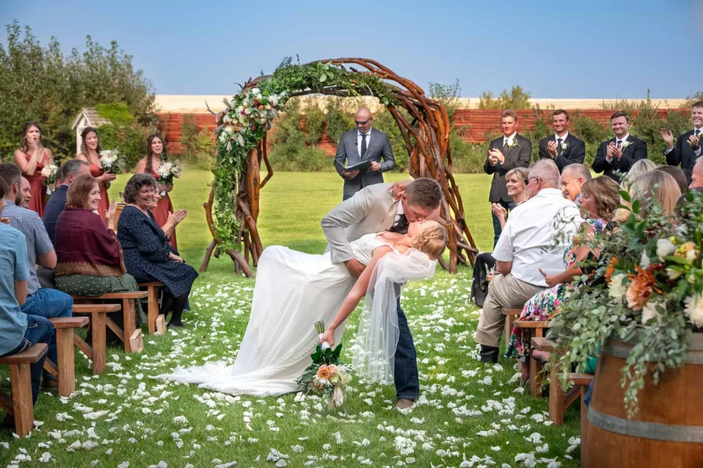 Groom kisses bride in the isle at Rockin TJ Ranch, Bozeman, Montana