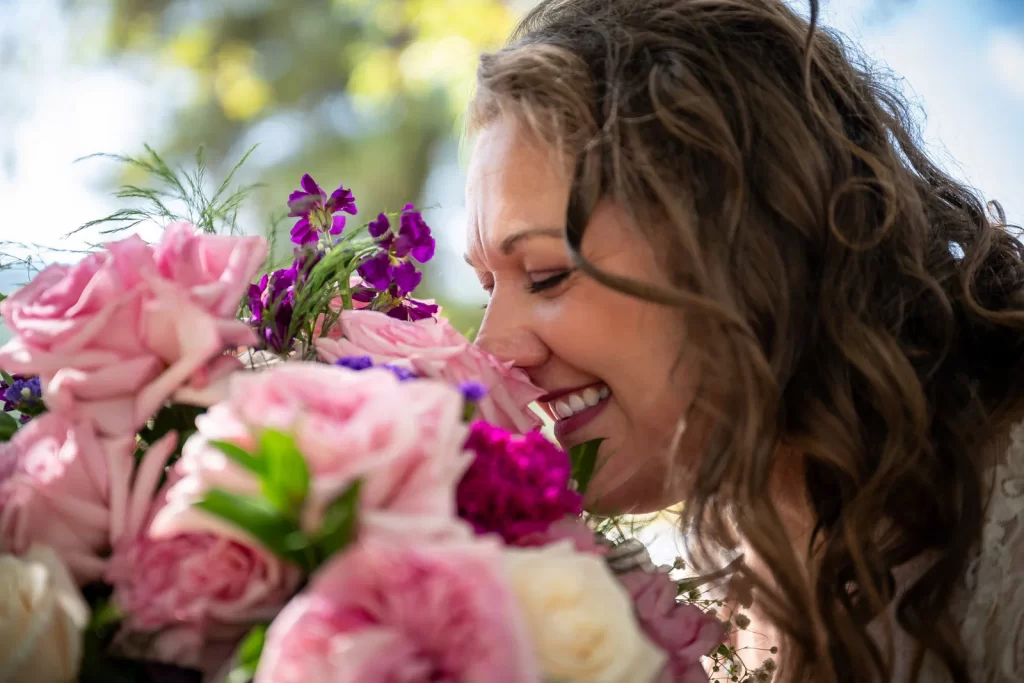 Bride smelling flowers