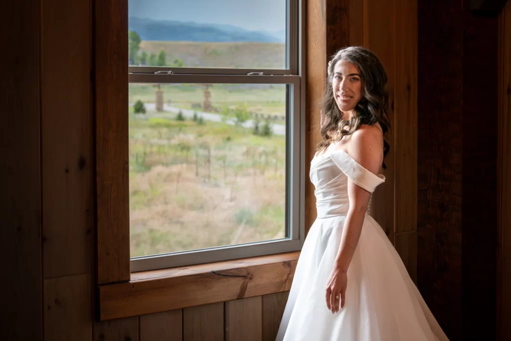 Bride standing next to window with natural light