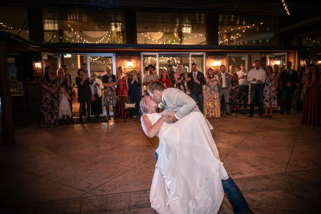 Bride and groom kissing on dance floor